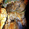 Crystal Cave : http://en.wikipedia.org/wiki/Crystal_Cave_(Sequoia_National_Park)
 
Formed of marble, the Crystal Cave is decorated with curtains of icicle-like stalactites and mounds of stalagmites.  To reach it, you must drive to the end of the twisting, seven-mile road heading west from the General’s Highway, two miles south of the Moro Rock turnoff.  Trailers, RVs and buses are prohibited because of the road's narrowness.  Then, from the parking area, it is a 15-minute hike down a steep path to the cave entrance.  The cave can be toured in summer only.  The Sequoia Natural History Association offers 45-minute guided tours daily every half hour between 11 a.m. and 4 p.m. from mid-June to early September (less often in early May and late September).  Cave temperature is a constant 48 degrees so a jacket or sweater is recommended.